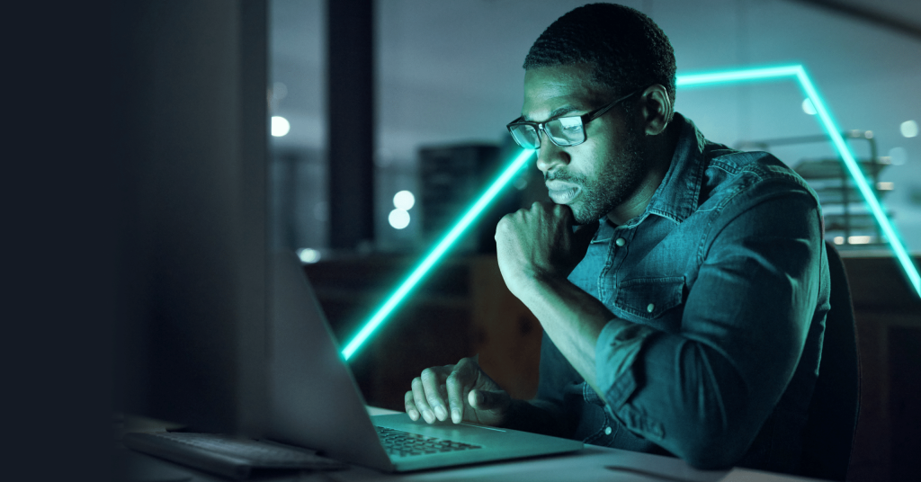 Man wearing spectacles is focused on his laptop