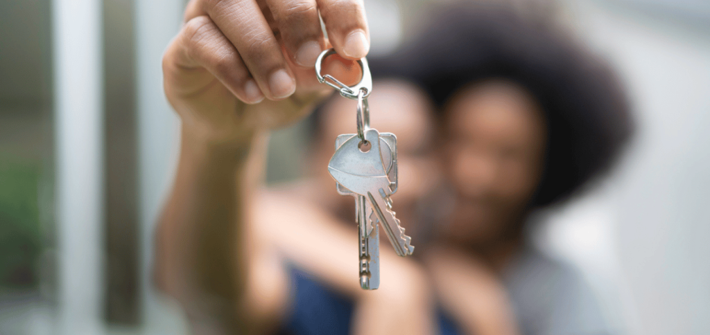 A hand holding the keys