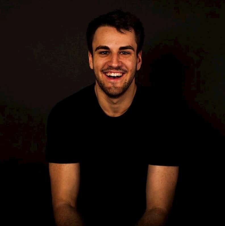 Portrait of a smiling man in a black background